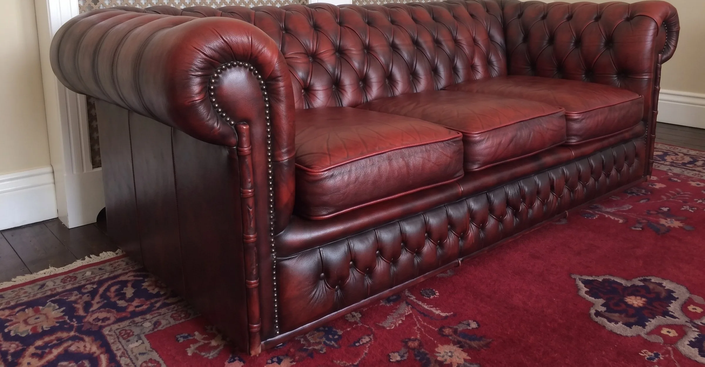 Oxblood Chesterfield sofa after recolour and conditioning
